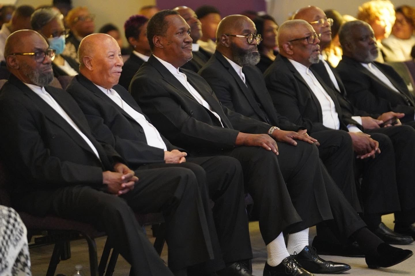 Men embracing at New Hope Cathedral